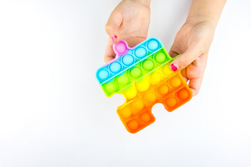 Girl holding Anti stress Popit toy isolated on the white background