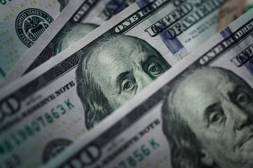 Several one hundred dolar bills. Extreme macro close up, focusing on the eyes of Benjamin Franklin. - obrazy, fototapety, plakaty