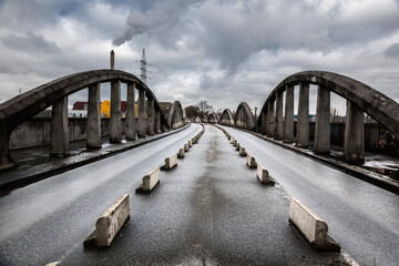 Brussels, Belgium -   03 28 2018: Old Industrial bridge called Leeuwoprit - Rampe du Lion -  Albertbridge with bad weather comming