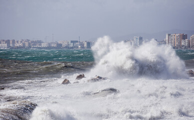 Naklejka na ściany i meble big waves breaking on the shore, with white foam