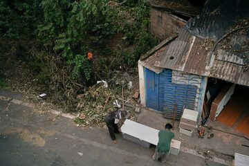 Super cyclone amphan destroyed workshop on Howrah, West Bengal, India. Two persons trying to restore the factory.