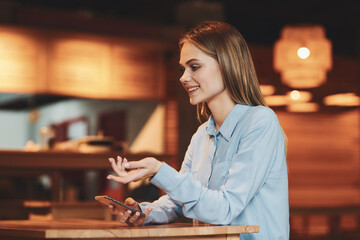 Business woman in a cafe in the summer outdoors on vacation