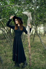 woman in black suit Witch in a fantasy forest