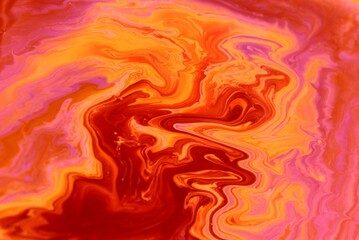 Abstract red marble background. Acrylic texture with marble pattern. Mixing colors creates an interesting structure. It is well suited for laptop background and wallpaper, fabric