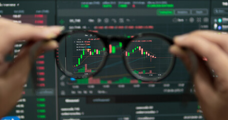 Hand holding glasses trade financial stocks and investments