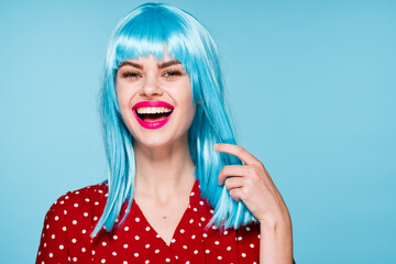 joyful woman in purple wig glamor posing blue background