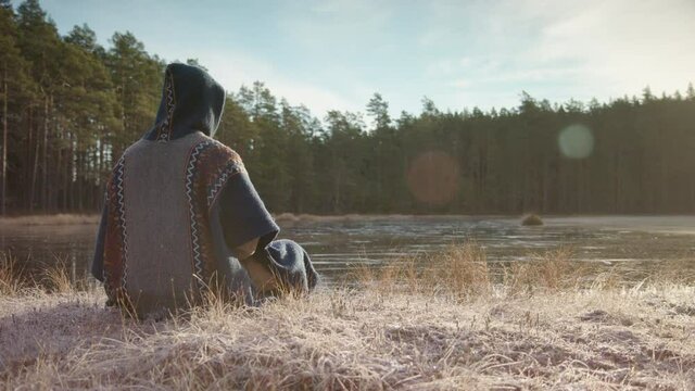SLIDER shot of an ice bather in meditation practice before going in a frozen lake