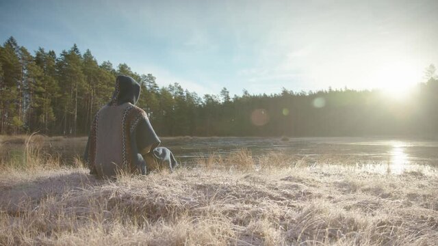 TRACKING shot L-R of an ice bather conscious breathing before going in a frozen lake