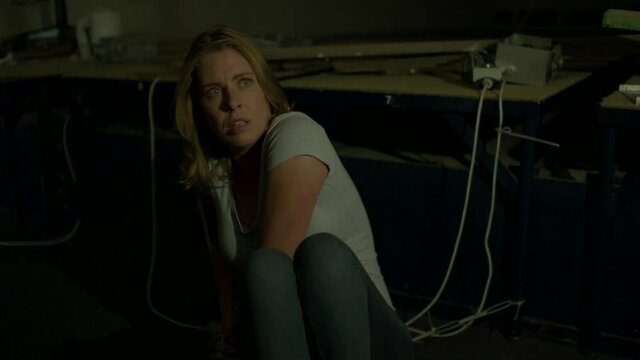 Tied up woman trying to get away from her kidnapper in a scary basement