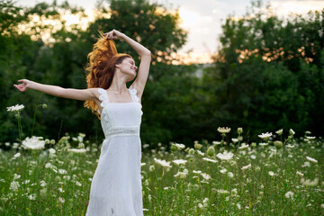 Obraz premium Woman in white dress in a field flowers sun nature freedom