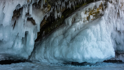 The base of the rock is covered with a thick layer of bizarre icicles and splashes. Fragments of...