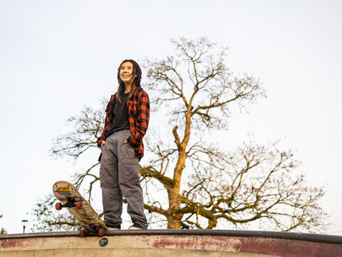 Young Indigenous non-binary skater outdoors