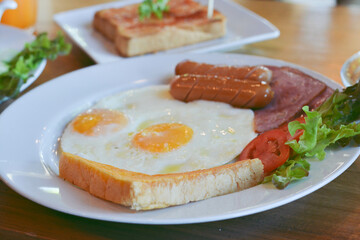 Full American Breakfast with Eggs, Bacon Sausage and Vegetable, selective focus.