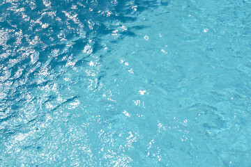 Water and air bubbles over blue background in swimming pool.