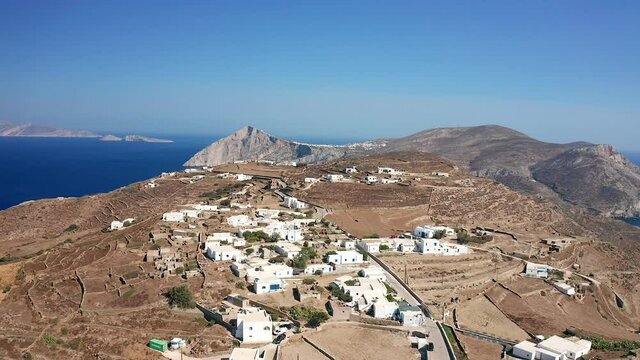 Flying forward over Traditional Village Ano Meria, Folegandros island, aegean sea Background