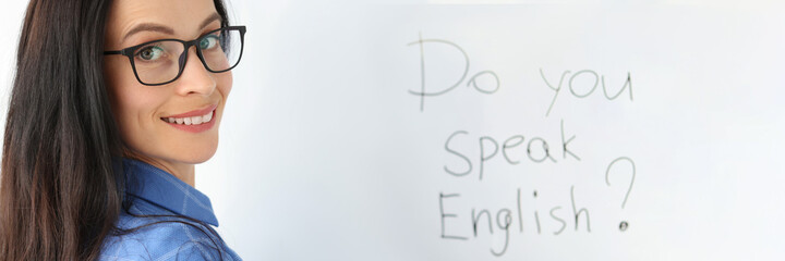 Lettering do you speak english on white board closeup