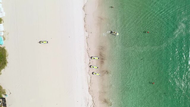 person on water power sport mobile jet ski riding in an ocean by the beach