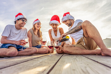 Happy people enjoying outdoor life in exotic vacation resort drinking alcohol. Group of young...