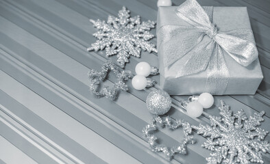 Silver gold Christmas gifts with snow background. silver decorations on pastel silver background. Flat lay, top view, Presents for Birthdays. Box with gifts tied with ribbon and bows. happy new year
