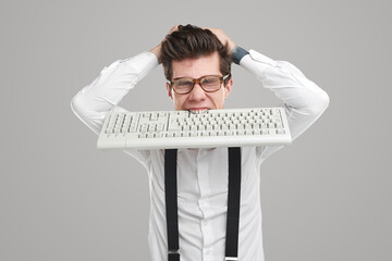 Stressed programmer with keyboard in mouth