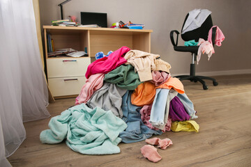 Pile of carelessly scattered clothes on floor.