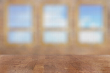 Fototapeta na wymiar wooden table in the room with big windows