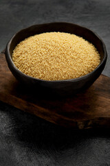 Couscous on dark background.