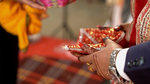 Close up of a couple throwing puffed rice in fire during traditional Hindu wedding. Slow motion shot