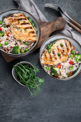 Grilled chicken with vegetables and rice.