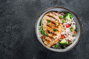Grilled chicken with vegetables and rice.