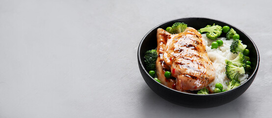 Grilled chicken with green vegetables and rice.