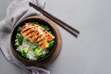 Grilled chicken with green vegetables and rice.