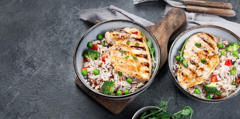 Grilled chicken with vegetables and rice.