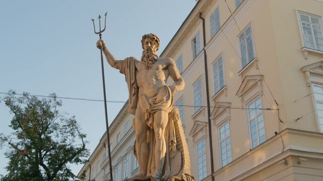 Neptune statue with town hall at background on Market square in Lviv, Ukraine