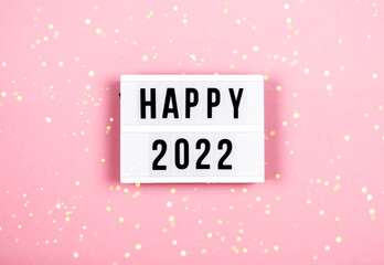 Happy New Year 2022 lletter board light box with christmas decorations and garland sparkling lights.CHristmas and holiday background banner