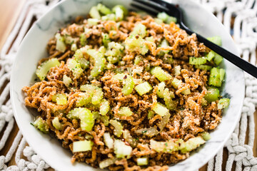 vegan instant noodles with ginger and soy sauce topped with celeri corainder seeds and chilli flakes, healthy plant-based food