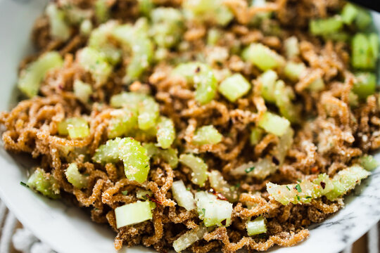 vegan instant noodles with ginger and soy sauce topped with celeri corainder seeds and chilli flakes, healthy plant-based food
