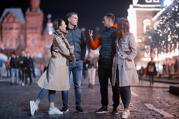 red square evening winter, a group of friends for a walk new year christmas moscow russia