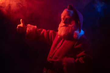 Santa claus in neon light on a black background. Christmas party.