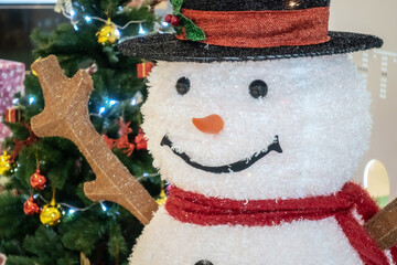 Snowman doll and Christmas tree on Christmas Eve