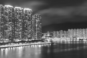 High rise residential building and harbor in Hong Kong city at night