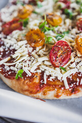 vegan margerita pizza with roasted cherry toatoes and dairy-free cheese, healthy plant-based food