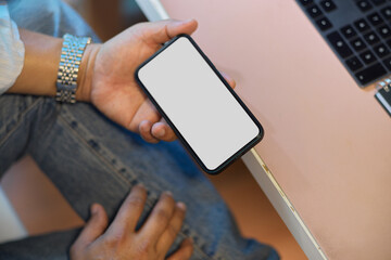 a male freelancer or businessman holding blank screen smartphone