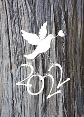 A dove carries the numbers of 2022 to wish the new year