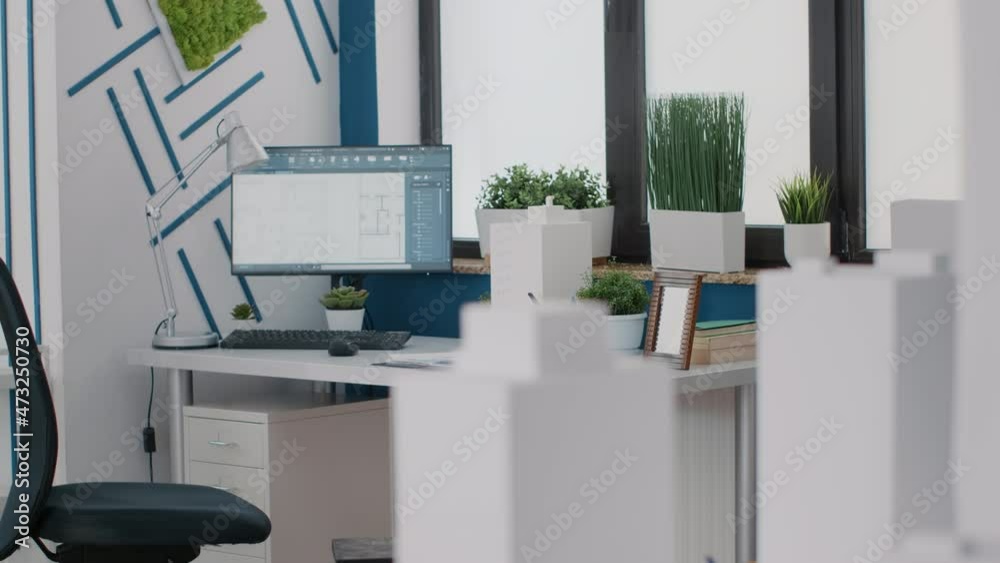Poster close up of desk in architectural office with digital blueprints plans on computer. monitor with ske