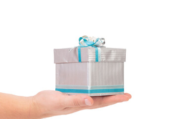 Gift box with blue bow in hand.