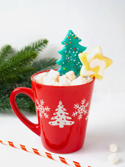 Red mug with hot chocolate with marshmallows.