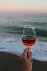 glass of red wine in hand