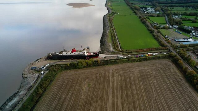 TSS Duke of Lancaster abandoned railway steamer ship docked in Mostyn Docks, River Dee, North Wales - aerial drone shot