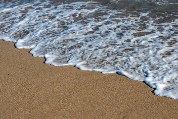 a small wave on the sand